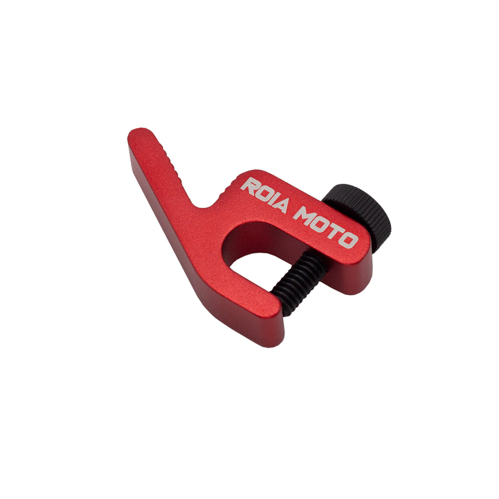 Red anodized ROIA MOTO tire bead retainer with engraved logo and black thumb screw, angled view on white